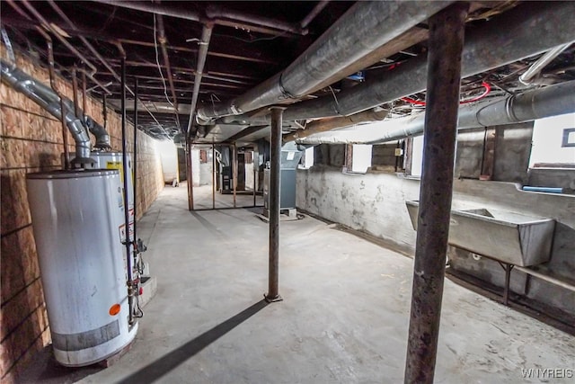 basement featuring water heater and heating unit