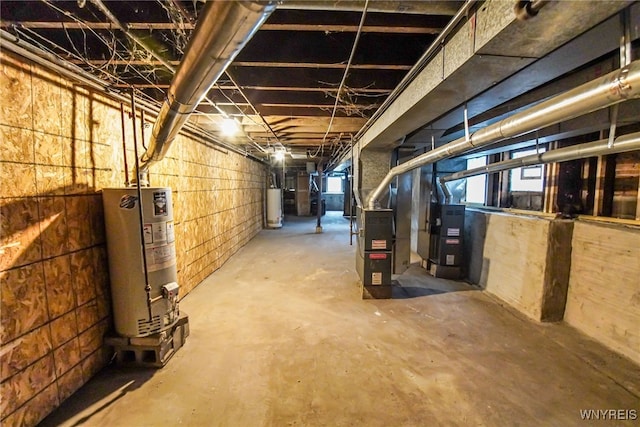 basement featuring heating unit and water heater