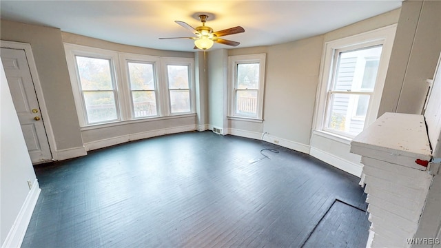 spare room with ceiling fan and dark wood-type flooring