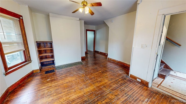 empty room with ceiling fan and dark hardwood / wood-style floors