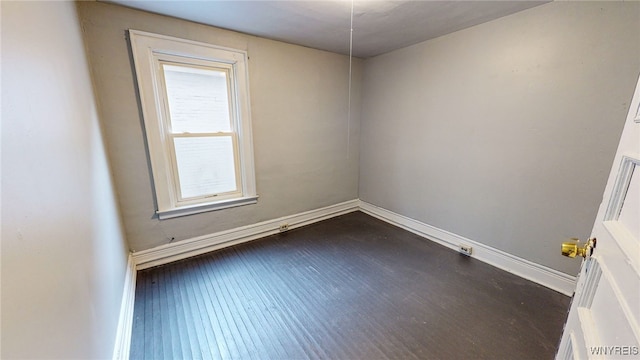 empty room with dark hardwood / wood-style floors