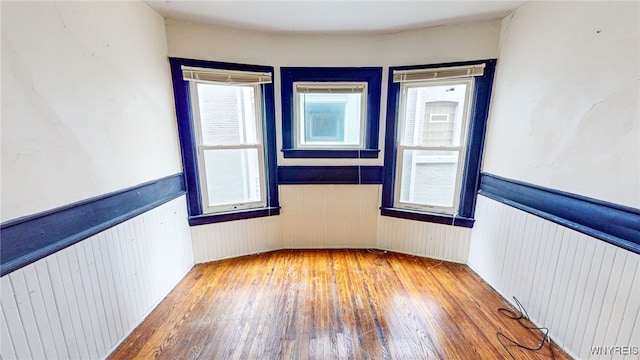 empty room with wood-type flooring and radiator heating unit