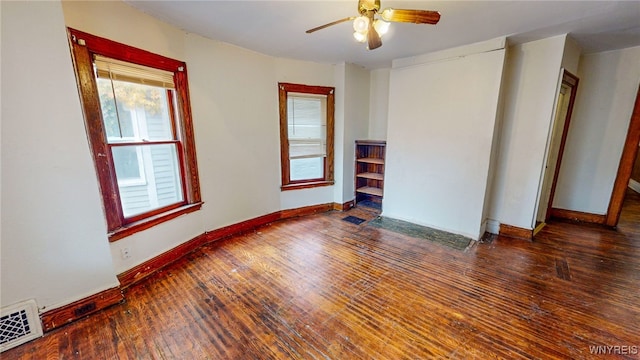 spare room featuring ceiling fan and dark wood-type flooring