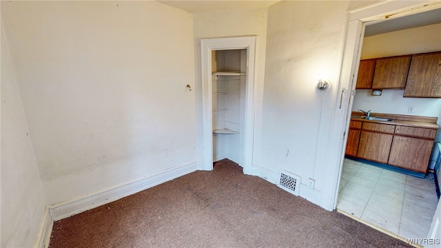 interior space with light carpet and sink