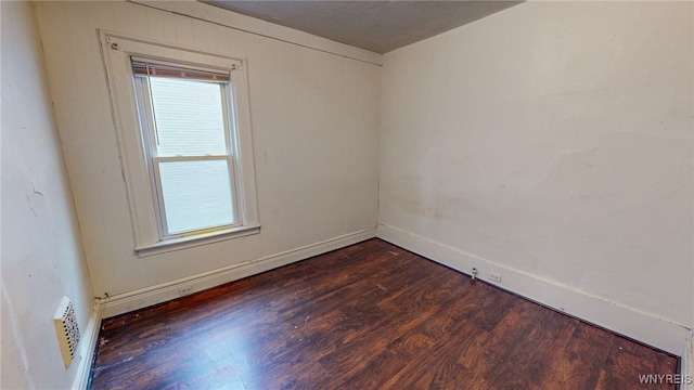 spare room with dark wood-type flooring