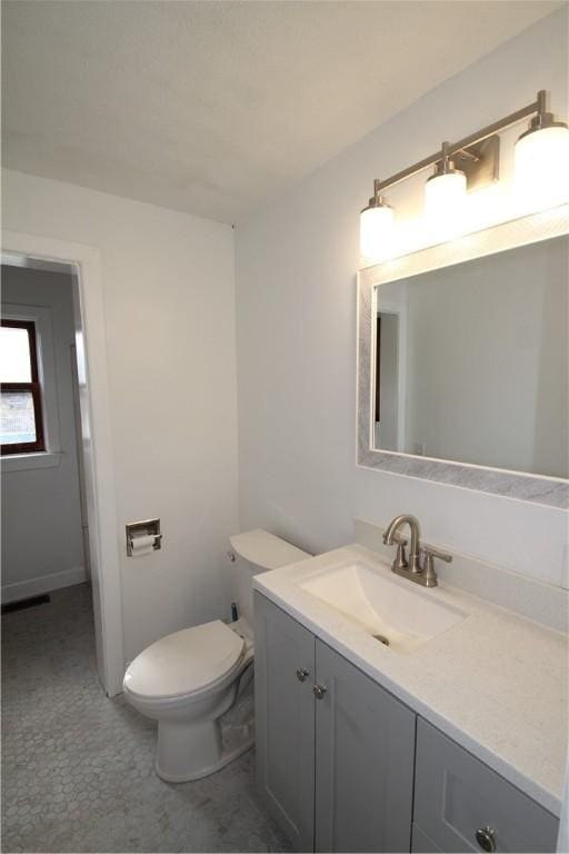 bathroom featuring toilet and vanity