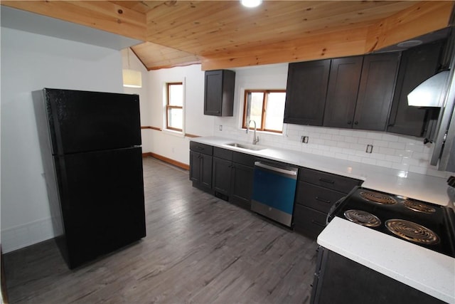 kitchen featuring tasteful backsplash, light countertops, freestanding refrigerator, a sink, and dishwasher