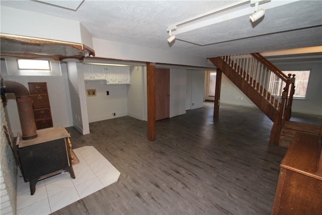 below grade area with stairs, light wood-style flooring, and a healthy amount of sunlight