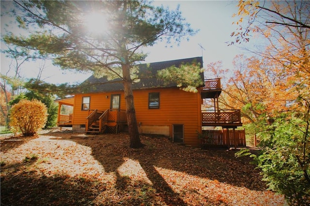 rear view of house with a wooden deck