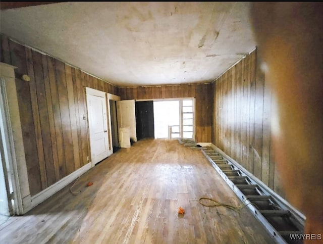 miscellaneous room with hardwood / wood-style floors and wood walls