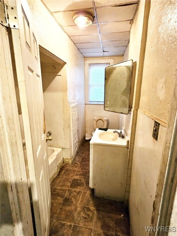 bathroom with a tub to relax in and vanity