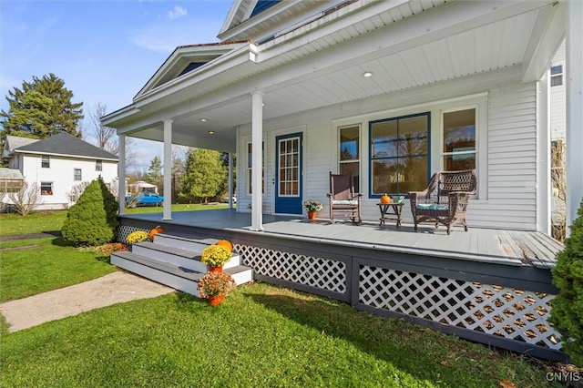 wooden terrace with a lawn and a porch