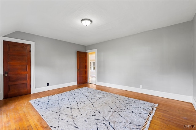 empty room with hardwood / wood-style flooring