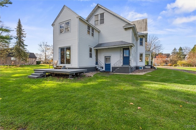 rear view of property with a yard