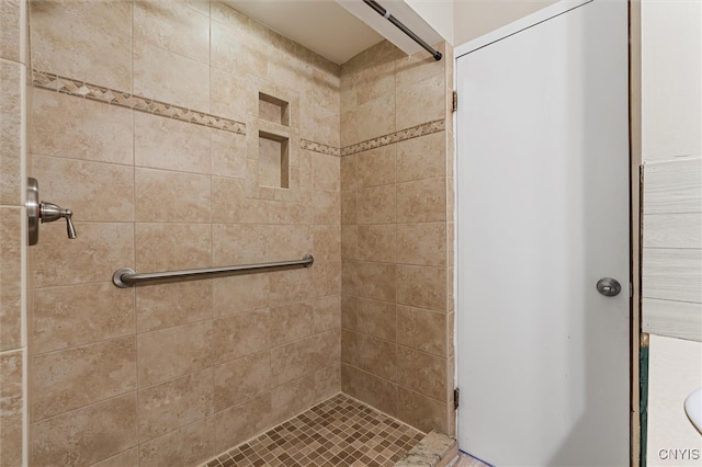 bathroom with a tile shower