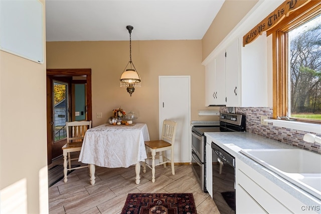 kitchen with white cabinets, pendant lighting, sink, and black appliances