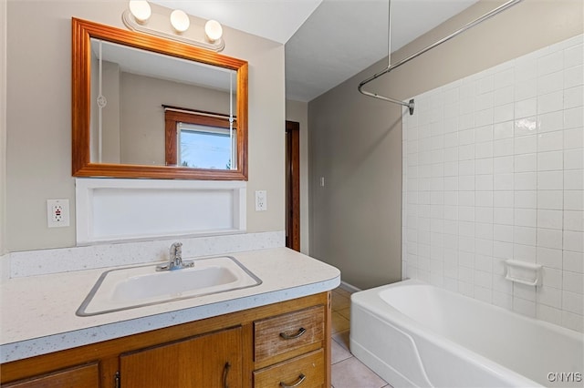 bathroom featuring tile patterned flooring, vanity, and tiled shower / bath combo