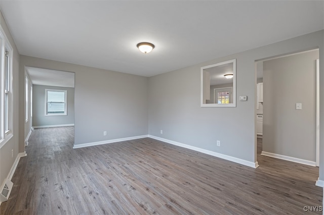 unfurnished room with hardwood / wood-style flooring