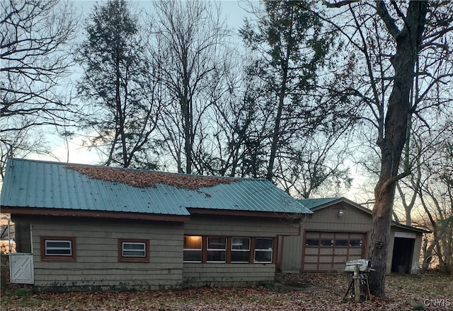 rear view of property featuring a garage