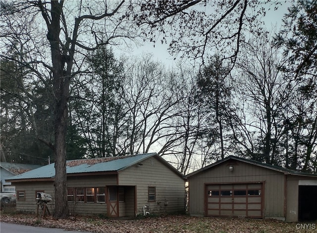 view of property exterior featuring an outbuilding and a garage