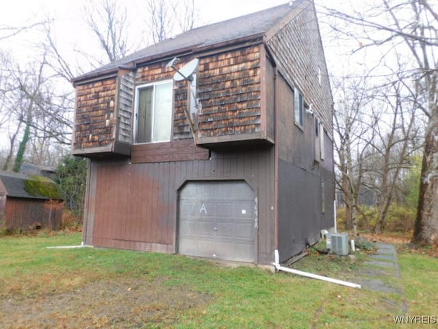 view of property exterior with central air condition unit and a garage