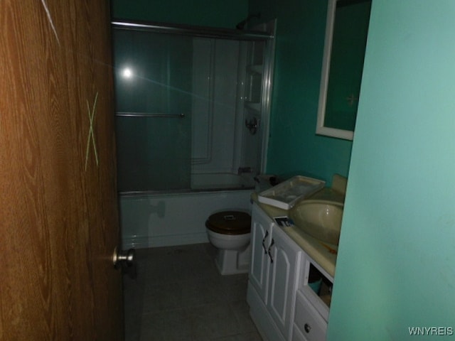 full bathroom with vanity, toilet, shower / bath combination with glass door, and tile patterned floors