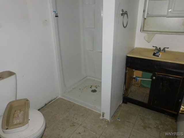 bathroom with a shower, tile patterned floors, toilet, and sink