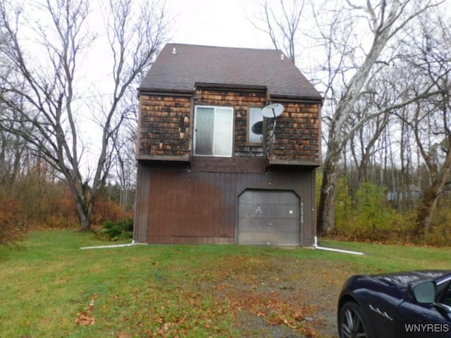 view of home's exterior with a yard and a garage