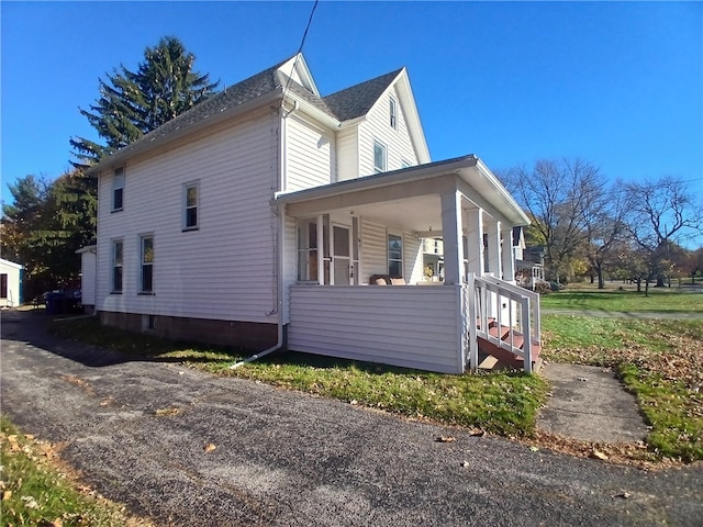 view of property exterior featuring covered porch