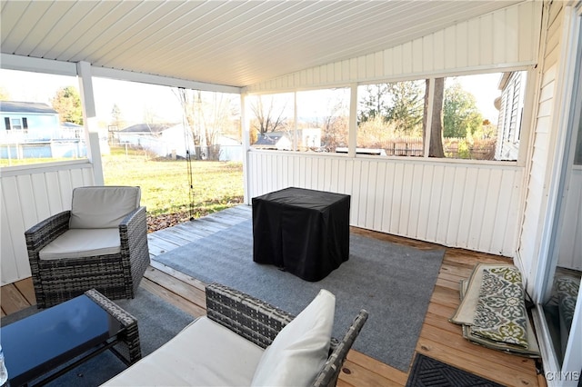 sunroom / solarium featuring vaulted ceiling