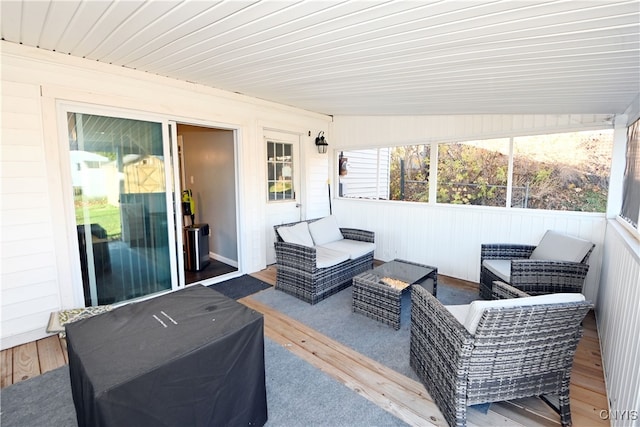 sunroom featuring vaulted ceiling