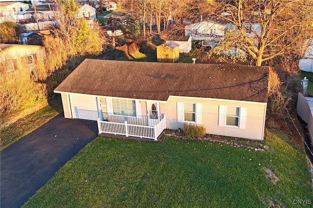 view of front facade with a front yard, a porch, and a garage