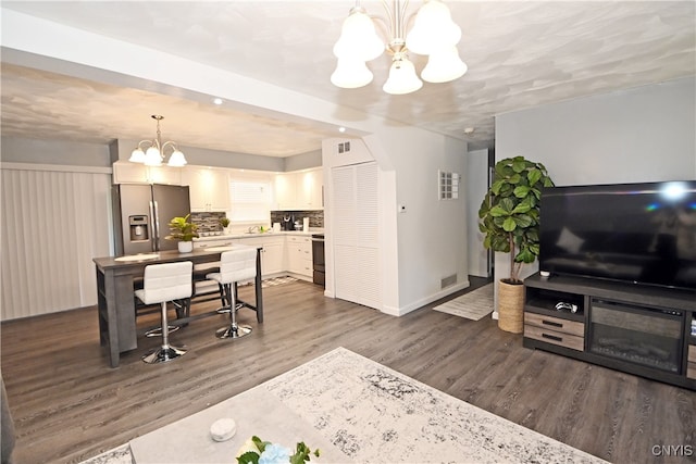 interior space with a chandelier and dark hardwood / wood-style floors