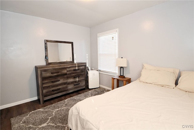 bedroom with dark hardwood / wood-style flooring