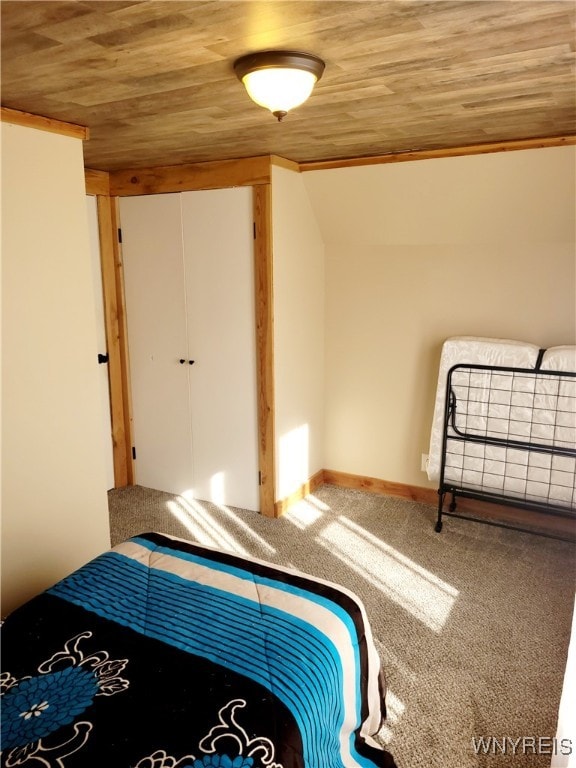 unfurnished bedroom featuring lofted ceiling, carpet floors, crown molding, and wooden ceiling