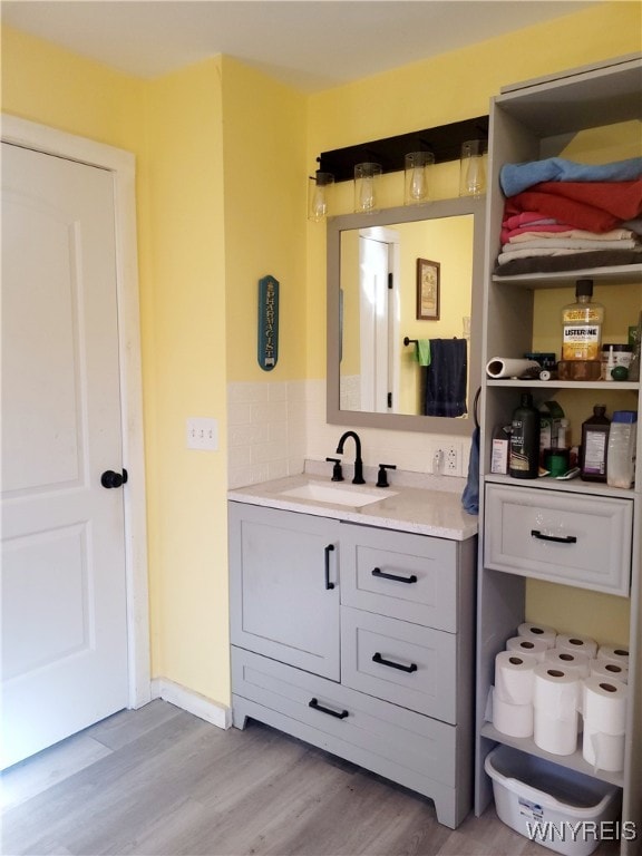 bathroom featuring hardwood / wood-style flooring and vanity