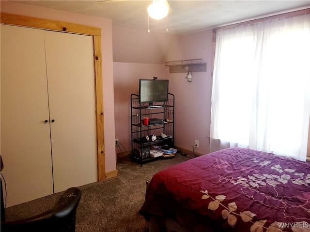 carpeted bedroom with a closet and ceiling fan