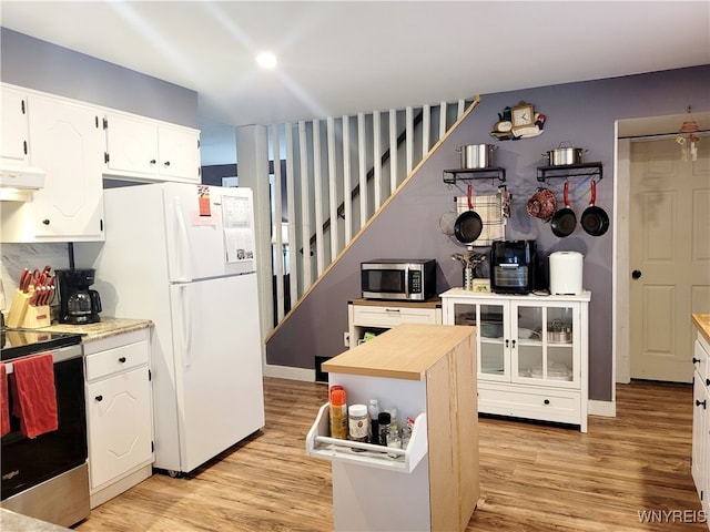 kitchen featuring light wood-type flooring, stainless steel appliances, and white cabinetry