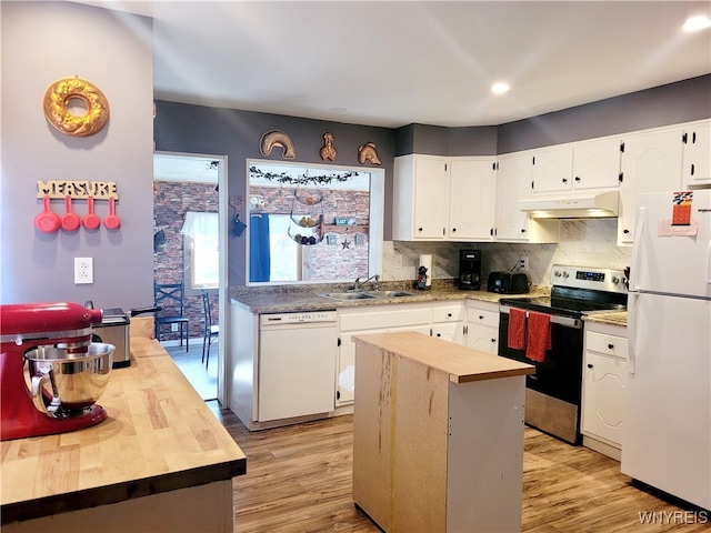 kitchen with light hardwood / wood-style flooring, white cabinets, white appliances, and a kitchen island