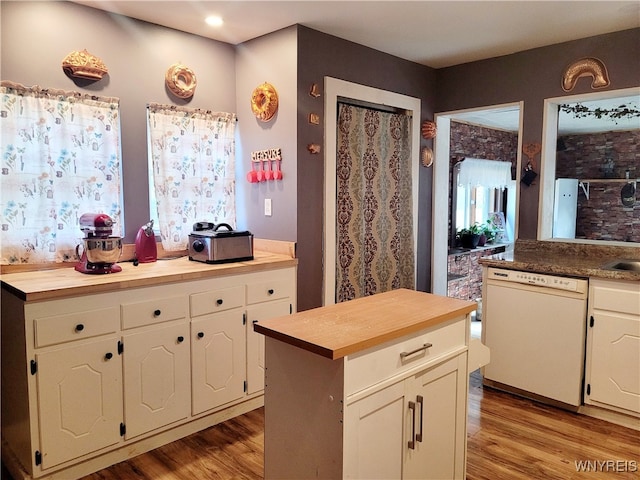 kitchen featuring wood counters, white dishwasher, light hardwood / wood-style floors, and a kitchen island