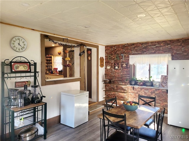 dining space with dark hardwood / wood-style floors and ornamental molding