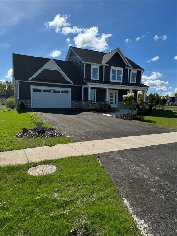 view of front of home with a front yard and a garage