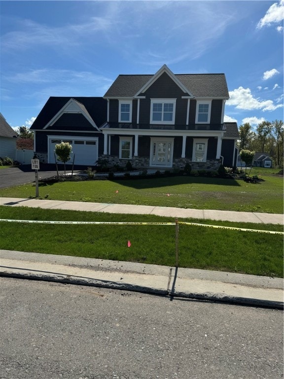 view of front of property featuring a front yard and a garage