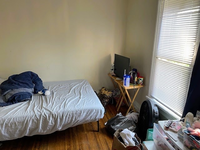 bedroom with dark wood-type flooring