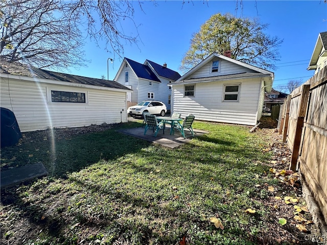 rear view of house with a patio area and a yard