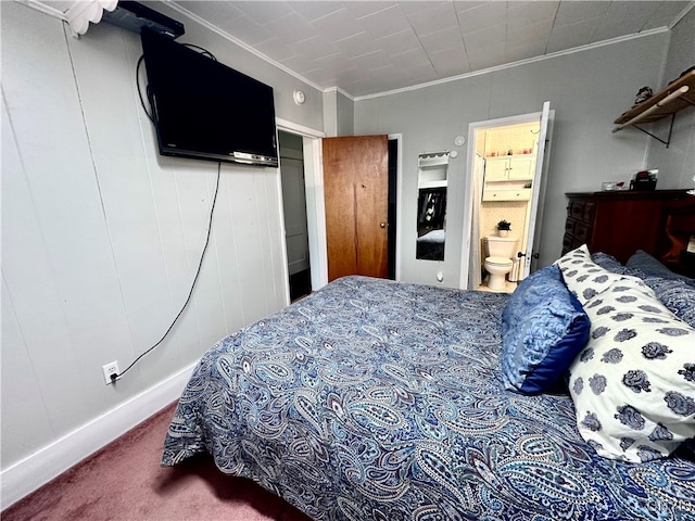 carpeted bedroom featuring crown molding and connected bathroom