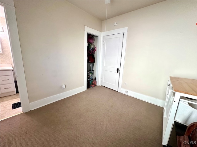 unfurnished bedroom featuring dark carpet