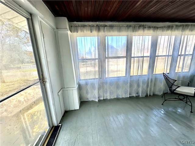 unfurnished sunroom with plenty of natural light and wood ceiling