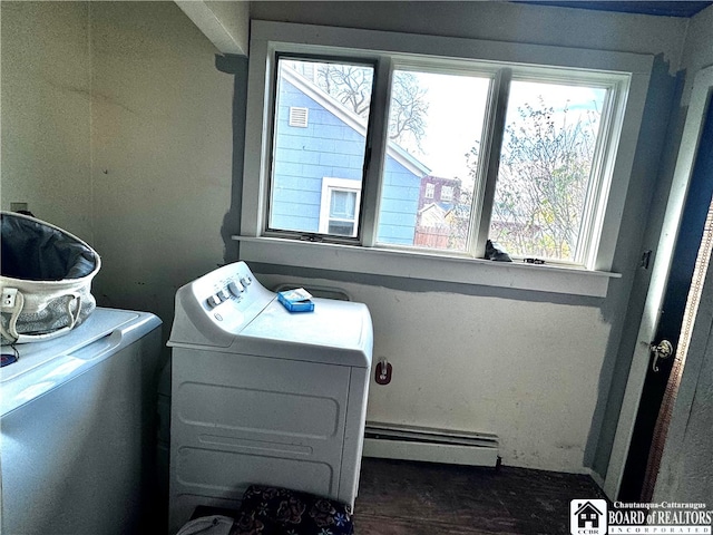 clothes washing area featuring separate washer and dryer and baseboard heating