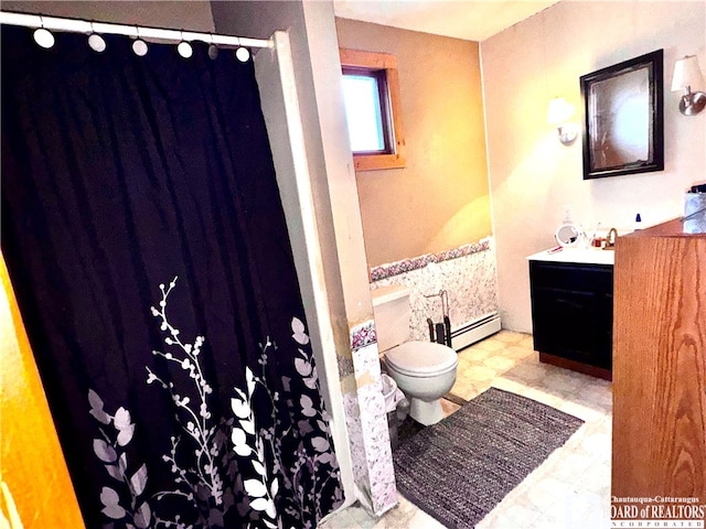 bathroom featuring vanity, toilet, and a baseboard heating unit